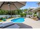 Inviting pool area with lounge chairs and umbrella, perfect for relaxing outdoors at 5 Ruth St., Murrells Inlet, SC 29576