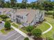 Aerial view of gray townhomes with well-manicured lawns, landscaping, and parking areas at 503 N 20Th Ave. N # 41D, North Myrtle Beach, SC 29582