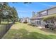 Backyard featuring a patio, lush lawn, tall trees, and a black metal fence at 503 N 20Th Ave. N # 41D, North Myrtle Beach, SC 29582