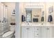 Well-lit bathroom featuring double vanity, white cabinetry, and beach-themed decor for a coastal feel at 503 N 20Th Ave. N # 41D, North Myrtle Beach, SC 29582