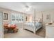 Cozy bedroom features a four-poster bed, ceiling fan, and a comfortable rattan chair with ottoman at 503 N 20Th Ave. N # 41D, North Myrtle Beach, SC 29582
