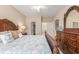 Spacious bedroom with an ornate wood bed frame, side tables and a dresser with ensuite bathroom and walk-in closet at 503 N 20Th Ave. N # 41D, North Myrtle Beach, SC 29582