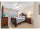 A well-lit main bedroom with a decorative wood bed frame, ceiling fan and side tables at 503 N 20Th Ave. N # 41D, North Myrtle Beach, SC 29582
