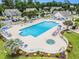 Aerial view of a community pool area with lounge chairs and lush landscaping at 503 N 20Th Ave. N # 41D, North Myrtle Beach, SC 29582