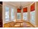 Sunny breakfast nook with large windows, a chandelier and access to a porch at 55 Pineberry Dr., Georgetown, SC 29440