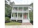 Inviting two-story home with double porches, white railings, and a striking pink front door at 55 Pineberry Dr., Georgetown, SC 29440