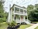 Stately two-story home with a double porch, white columns, and vibrant green lawn, perfect for outdoor enjoyment at 55 Pineberry Dr., Georgetown, SC 29440