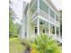 Charming two-story home with a double porch, detailed columns, and lush landscaping at 55 Pineberry Dr., Georgetown, SC 29440