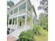 Beautiful two-story home with double balconies, lush landscaping, and a welcoming entrance at 55 Pineberry Dr., Georgetown, SC 29440