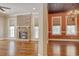 Open-concept living room featuring a brick fireplace, hardwood floors, and view to dining area at 55 Pineberry Dr., Georgetown, SC 29440