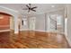 Open-concept living room with hardwood floors, arched doorways, and a view of the staircase at 55 Pineberry Dr., Georgetown, SC 29440