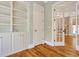 Open-concept living area with custom built-ins and a fireplace beyond the doorway at 55 Pineberry Dr., Georgetown, SC 29440
