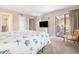Relaxing bedroom with balcony access, dresser, TV, and beach-themed decor at 5505 N Ocean Blvd. # 303, Myrtle Beach, SC 29577