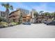 Coastal condo building with palm trees, ample parking, and tan wood siding at 5505 N Ocean Blvd. # 303, Myrtle Beach, SC 29577