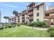 Exterior view of a condo complex with manicured lawns and a pathway to the pool and beach at 5505 N Ocean Blvd. # 303, Myrtle Beach, SC 29577