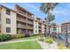 Condo exterior featuring multiple levels, balconies, lush landscaping, and a glimpse of the pool at 5505 N Ocean Blvd. # 303, Myrtle Beach, SC 29577