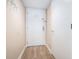 Hallway with wood-look flooring leading to white fire door and white closet door at 5505 N Ocean Blvd. # 303, Myrtle Beach, SC 29577