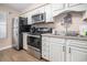 This kitchen features stainless steel appliances, white cabinets, and modern fixtures at 5505 N Ocean Blvd. # 303, Myrtle Beach, SC 29577