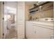 Convenient laundry area with washer, dryer, and shelving for storage at 5505 N Ocean Blvd. # 303, Myrtle Beach, SC 29577