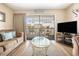 Living room featuring neutral tones, balcony, and comfortable seating arrangement at 5505 N Ocean Blvd. # 303, Myrtle Beach, SC 29577