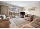 Cozy living room with sliding glass doors to balcony and beach decor at 5505 N Ocean Blvd. # 303, Myrtle Beach, SC 29577