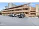 Condo parking lot with marked spaces, palm trees, and exterior view of the building at 5505 N Ocean Blvd. # 303, Myrtle Beach, SC 29577