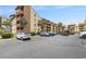 Exterior view of a condo complex from the parking lot, showcasing ample parking and palm trees at 5505 N Ocean Blvd. # 303, Myrtle Beach, SC 29577