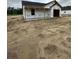 New construction shows a covered porch framed on a flat lot with trees in the background on an overcast day at 5729 S Highway 41, Marion, SC 29571