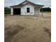 New construction home featuring attached garage and covered entrance, set in a partially cleared lot at 5733 S Highway 41, Marion, SC 29571