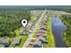 Community aerial view highlighting the neighborhood layout, proximity to lake and surrounding green spaces at 597 Heritage Downs Dr., Conway, SC 29526
