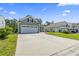 Charming home with a two-car garage and spacious driveway, surrounded by lush landscaping at 597 Heritage Downs Dr., Conway, SC 29526