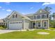 Charming two-story home with a two-car garage, manicured lawn, and beautiful curb appeal at 597 Heritage Downs Dr., Conway, SC 29526