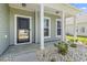 Inviting front porch with white columns and a pathway adorned with white stones and greenery at 597 Heritage Downs Dr., Conway, SC 29526