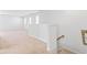 Hallway with carpet flooring, multiple windows, and white walls leading upstairs at 597 Heritage Downs Dr., Conway, SC 29526