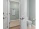 Hallway leading to a bathroom and laundry room with modern fixtures and finishes at 597 Heritage Downs Dr., Conway, SC 29526