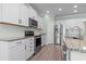 Modern kitchen featuring stainless steel appliances, granite countertops, and white cabinetry at 597 Heritage Downs Dr., Conway, SC 29526