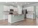 Spacious kitchen featuring white cabinets, stainless steel appliances, and a large island with granite countertops at 597 Heritage Downs Dr., Conway, SC 29526