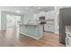 Modern kitchen featuring white cabinets, stainless steel appliances, and a spacious island with granite countertops at 597 Heritage Downs Dr., Conway, SC 29526