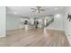 Spacious living room with a modern kitchen and staircase, plus beautiful hardwood floors at 597 Heritage Downs Dr., Conway, SC 29526