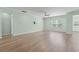 Large living room with hardwood floors, a ceiling fan, and large windows providing lots of natural light at 597 Heritage Downs Dr., Conway, SC 29526
