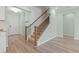Staircase with wood railing and decorative iron spindles, leading to the upper level of the home at 597 Heritage Downs Dr., Conway, SC 29526