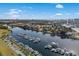 Aerial view showcases the marina and waterway with boats docked plus the downtown skyline in the distance at 6015 Catalina Dr. # 932, North Myrtle Beach, SC 29582