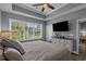 Spacious primary bedroom boasts a tray ceiling, large windows, a ceiling fan, and neutral paint for a calming ambiance at 6015 Catalina Dr. # 932, North Myrtle Beach, SC 29582