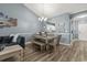 Dining area with wood floors, seating for six, and open layout to the living room at 6015 Catalina Dr. # 932, North Myrtle Beach, SC 29582