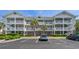 Inviting condo exterior with multiple balconies, palm trees, and convenient parking at 6015 Catalina Dr. # 932, North Myrtle Beach, SC 29582