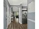 Bright hallway featuring wood floors, stainless steel refrigerator, and arched doorway at 6015 Catalina Dr. # 932, North Myrtle Beach, SC 29582