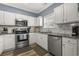 Bright kitchen featuring white cabinets, stainless steel appliances, granite countertops, and a subway tile backsplash at 6015 Catalina Dr. # 932, North Myrtle Beach, SC 29582