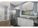 Kitchen with stainless steel refrigerator, granite countertops, white cabinets, and an opening to the living area at 6015 Catalina Dr. # 932, North Myrtle Beach, SC 29582