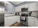 Well-lit kitchen boasts white cabinetry, granite countertops, stainless steel appliances, and an open design concept at 6015 Catalina Dr. # 932, North Myrtle Beach, SC 29582