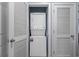 Laundry closet with stacked washer and dryer units and louvered doors at 6015 Catalina Dr. # 932, North Myrtle Beach, SC 29582